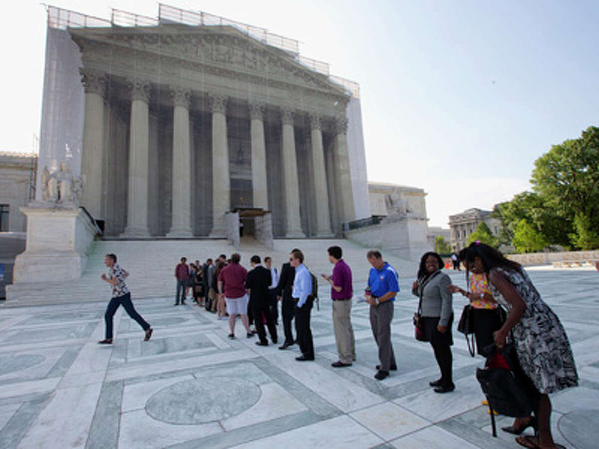 FILE - Visitors wait outside the Supreme Court in Washington on June 20, 2013. The New York Times reported Tuesday the U.S. Justice Department would examine and potentially litigate affirmative action policies at America's schools.