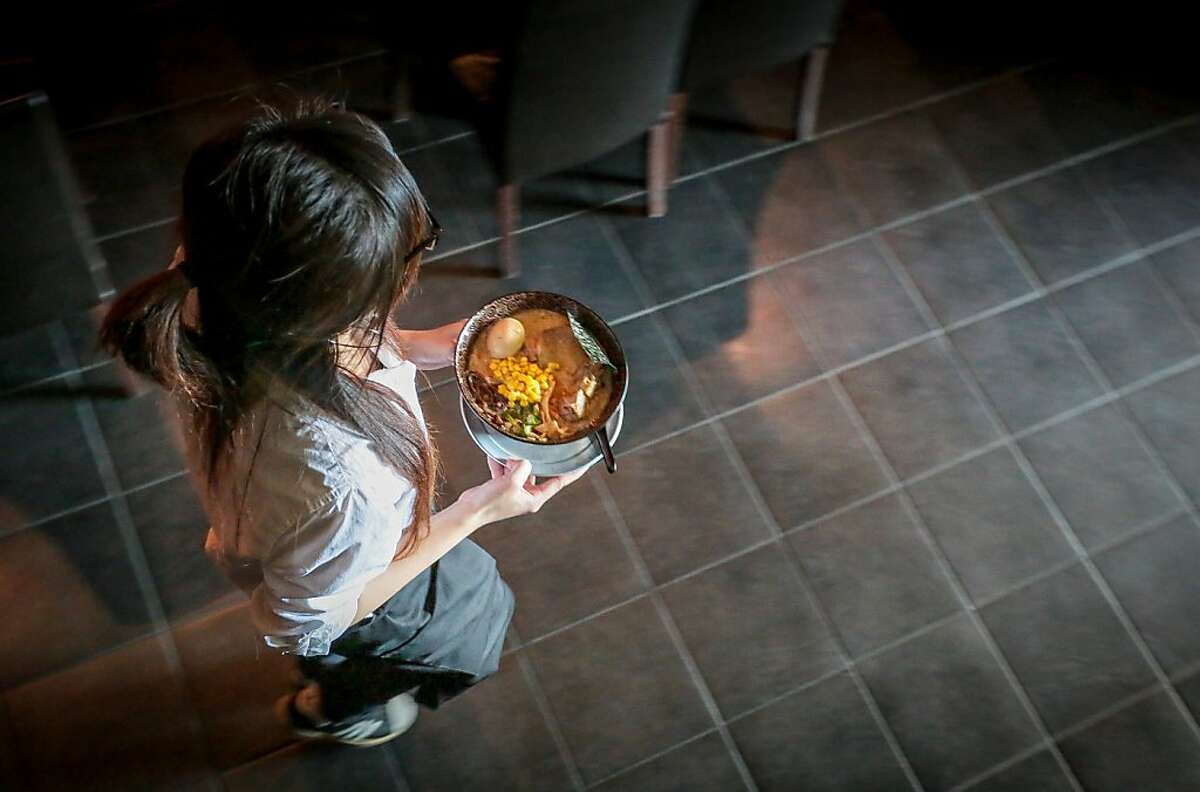 A server brings out Ramen from the kitchen at Waraku in San Francisco, Calif., on Thursday, May 9th, 2012.
