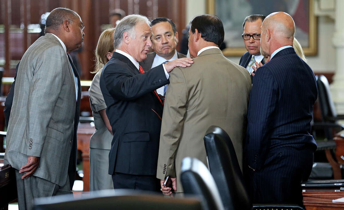 Democratic caucus leader Sen. Kirk Watson of Austin talks with Sen. Eddie Lucio Jr. of Brownsville, who supports a bill for tougher rules on abortions but voted against suspending rules so the bill could be taken up by the Senate on Monday.