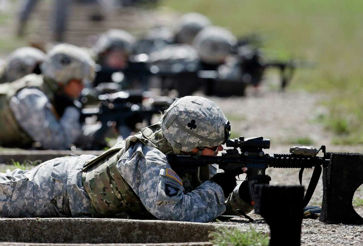FILE - In this Sept. 18, 2012 file photo, female soldiers from 1st Brigade Combat Team, 101st Airborne Division train on a firing range while testing new body armor in Fort Campbell, Ky., in preparation for their deployment to Afghanistan. Women may be able to begin training as Army Rangers by mid-2015, and as Navy SEALs a year later under broad plans Defense Secretary Chuck Hagel is approving that would slowly bring women into thousands of combat jobs, including those in the country�s elite special operations forces, according to details of the plans submitted to Hagel that were obtained by The Associated Press. (AP Photo/Mark Humphrey, File)