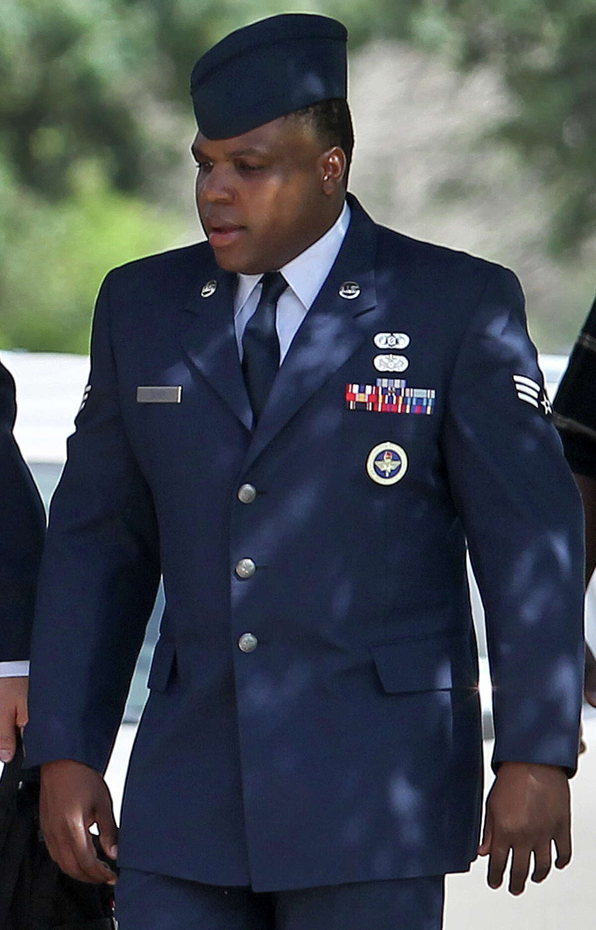 Senior Airman Christopher Oliver walks Monday June 24, 2013 at Joint Base San Antonio-Lackland. Oliver is facing a court-martial on charges of aggravated sexual assault and abusive sexual conduct of one basic training recruit and other charges.