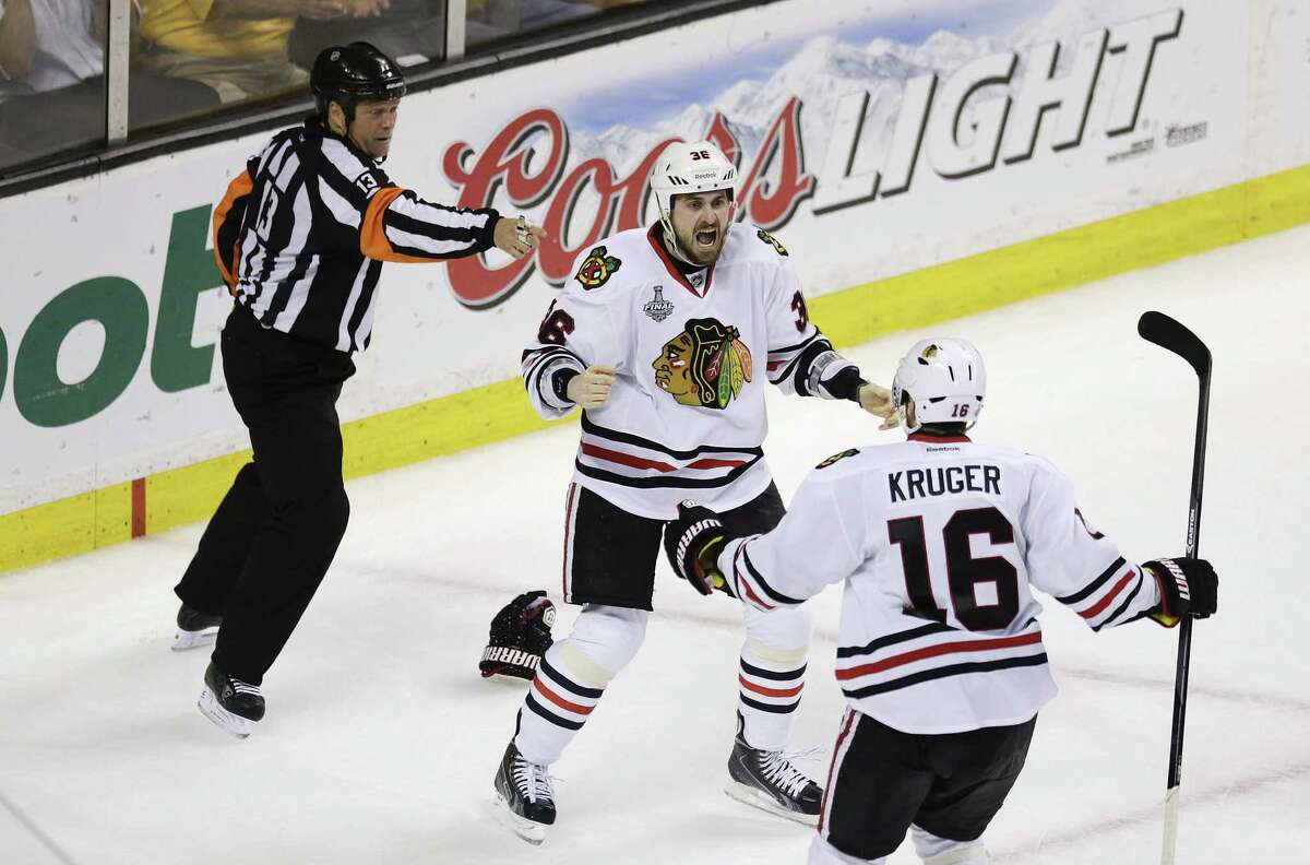 Chicago's Dave Bolland (left) celebrates his game-winning goal in the final minute with Marcus Kruger in Boston. The Blackhawks scored twice in the final 1:16 to win the Stanley Cup.
