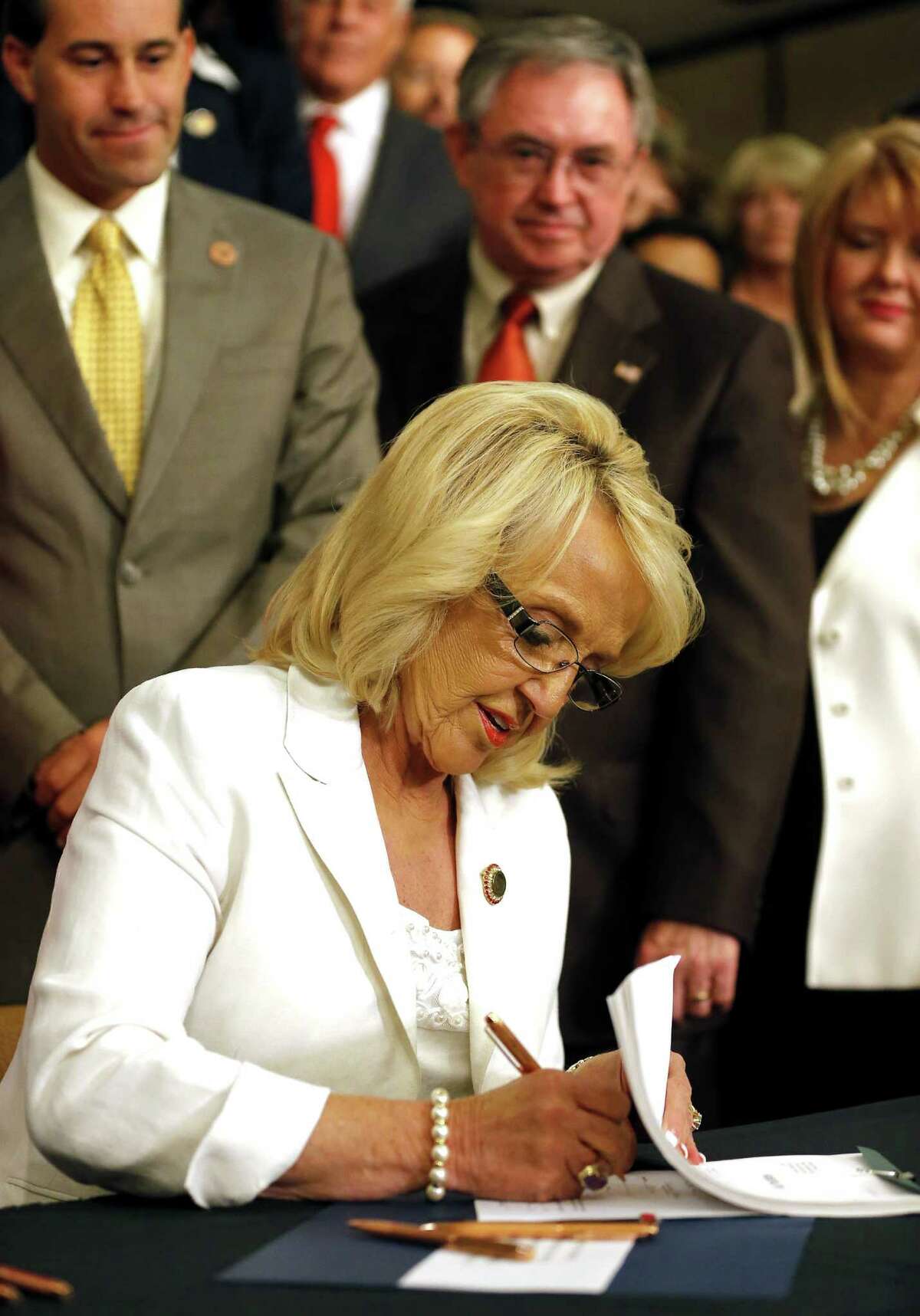 Arizona Republican Gov. Jan Brewer signs the Medicaid expansion law June 17 in a victory over conservatives in her own party opposed to President Obama's health care overhaul.