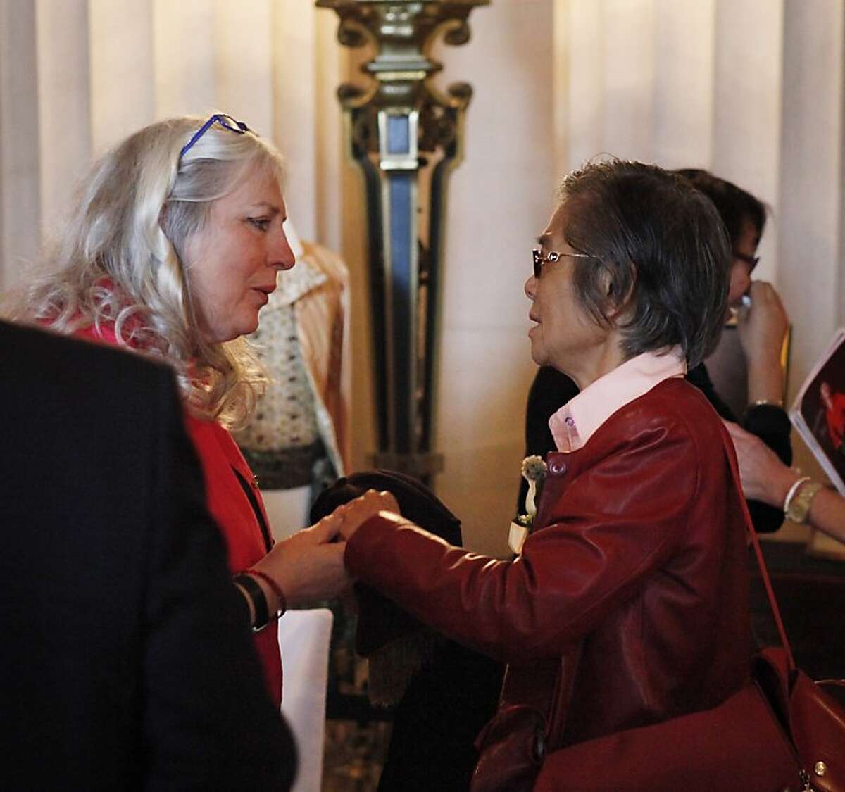 Judi Larson, Zheng Cao's sister-in-law, speaks with Xiaojiao Huang, Zheng Cao's mother, at the War Memorial Opera House for a memorial concert for Cao on Monday, June 24, 2013, in San Francisco, Calif. The Chinese-born mezzo soprano died this year after a long struggle with cancer.
