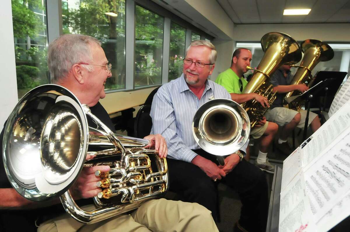 Karl Mohn, left, and Ron Graves socialize before they practice patriotic tunes at Lone Star College for their Independence Day salute on June 30.