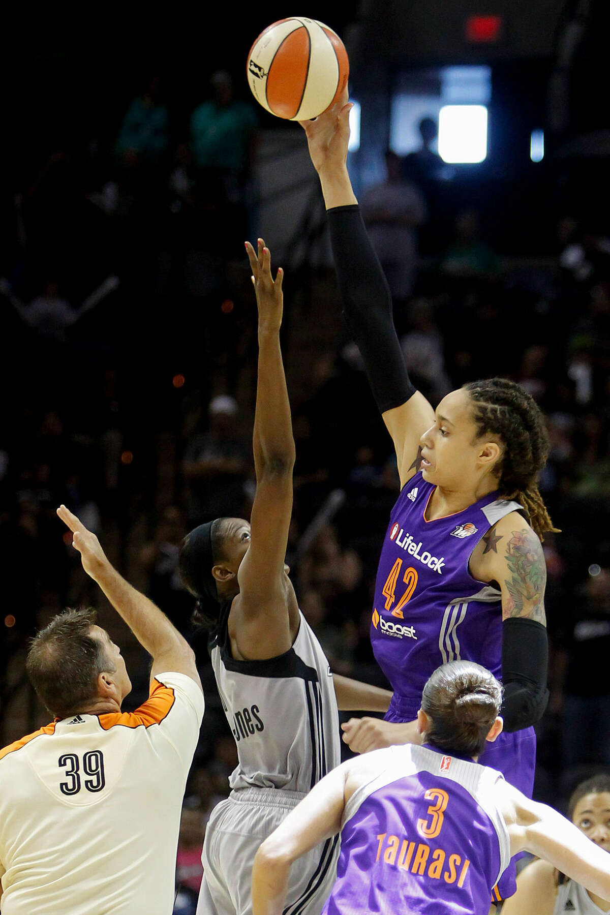 Phoenix center Brittney Griner controls the opening tip against the Silver Stars' DeLisha Milton-Jones. The ex-Baylor superstar had 26 points, seven rebounds and five blocks in her first WNBA game in San Antonio.
