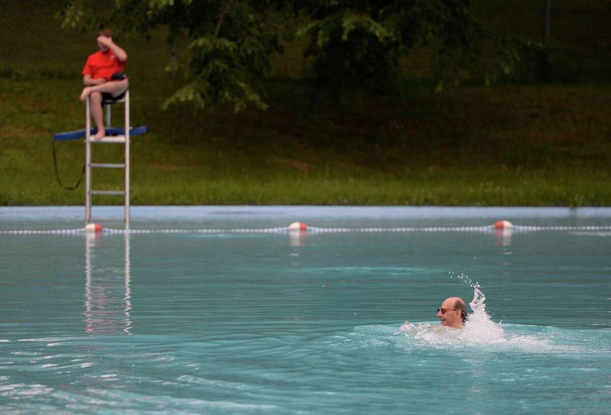 Mark Telford, right, is the first to hit the water at the Central Park pool opening day June 26, 2013, in Schenectady, N.Y. ( Skip Dickstein/Times Union )