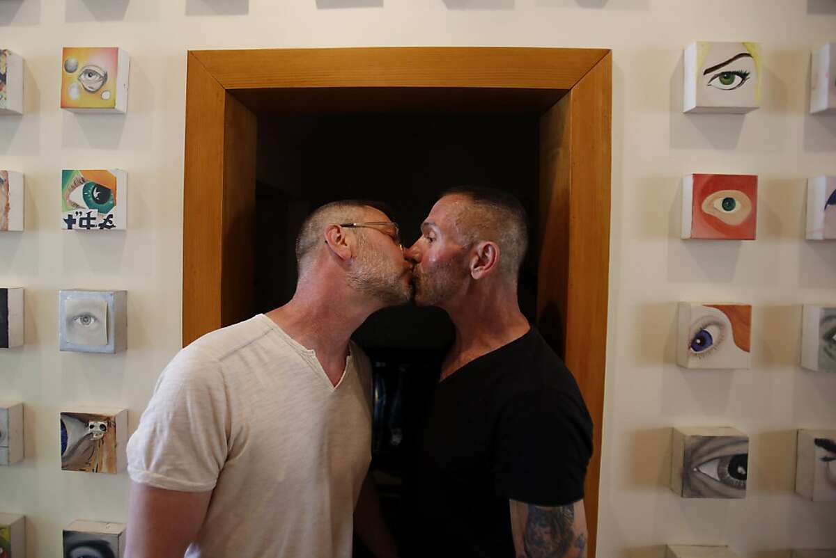 Anthony Makk, left, and Bradford Wells, right, kiss while posing for a portrait at their home in San Francisco, Calif. on June 26, 2013 after DOMA was ruled unconstitutional.