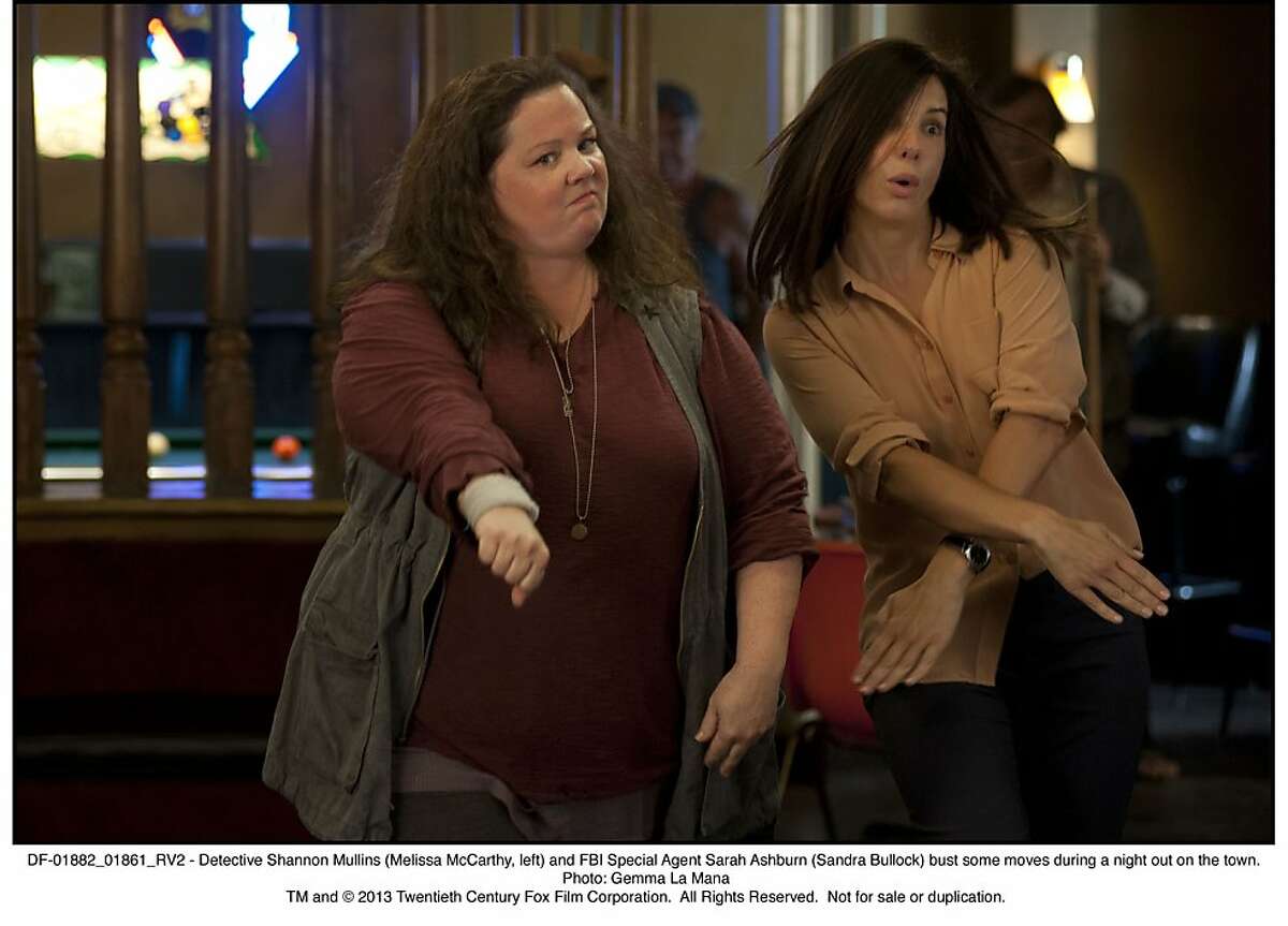 DF-01882_01861_RV2 - Detective Shannon Mullins (Melissa McCarthy, left) and FBI Special Agent Sarah Ashburn (Sandra Bullock) bust some moves during a night out on the town.