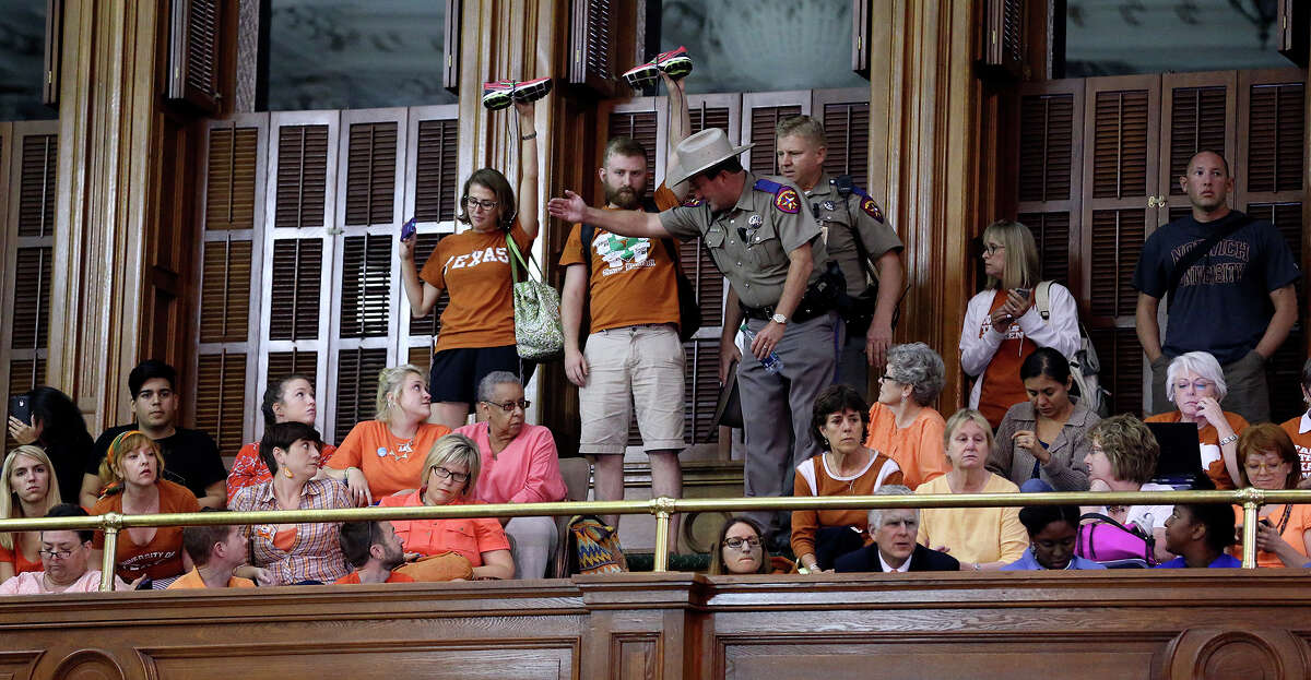 Spectators show support as Fort Worth Senator Wendy Davis filibusters in an effort to cause abortion legislation to die without a vote on the floor of the Senate Tuesday, June 25, 2013.