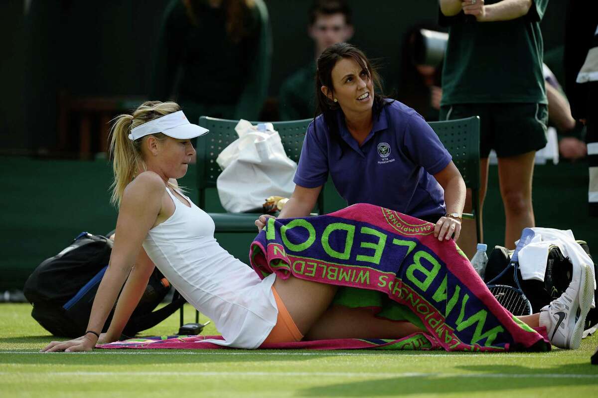 Sharapova, getting treatment during her match, managed to finish despite losing her footing several times.