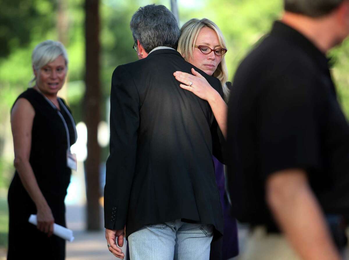 A family friend hugs Leslie Lambert, granddaughter of murder victim Dorothy Booth, after the execution.