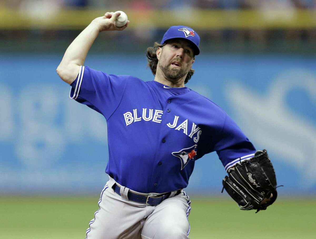 Toronto's R.A. Dickey held Tampa Bay to two hits in his first complete game since joining the Jays.