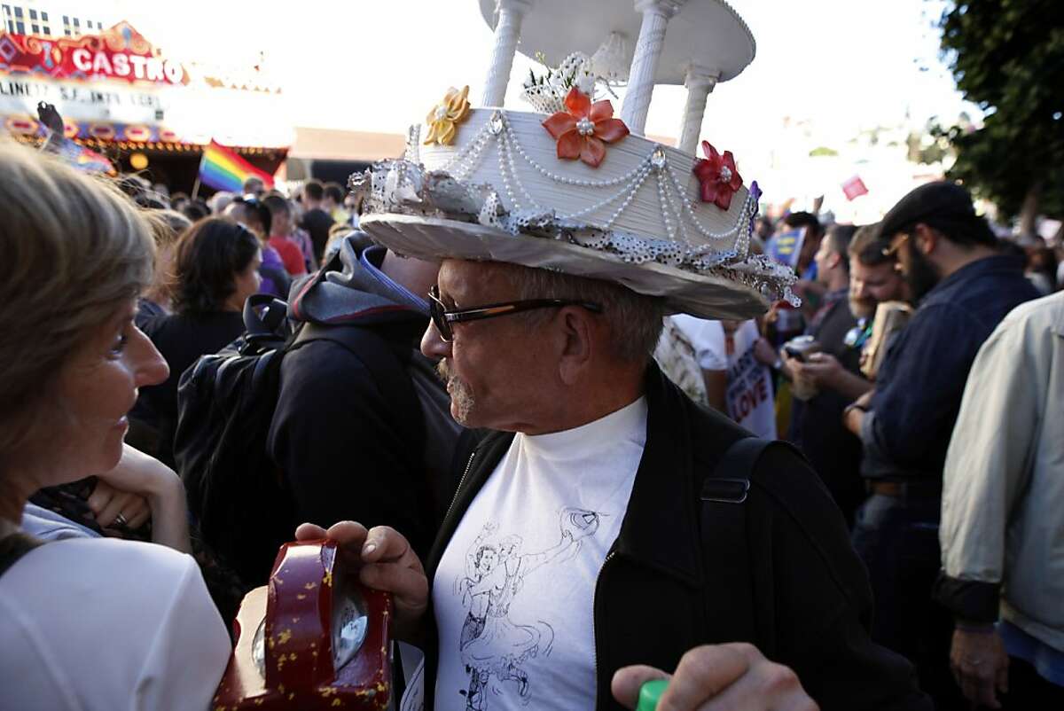 Miguel Gutierrez walks down Castro Street wearing a wedding cake hat to celebrate the Supreme Court decisions on DOMA and Prop. 8. Thousands gathered in the Castro district of San Francisco, Calif., on June 26, 2013, to celebrate the dismissal of the appeal of Proposition 8 by the U.S. Supreme Court.