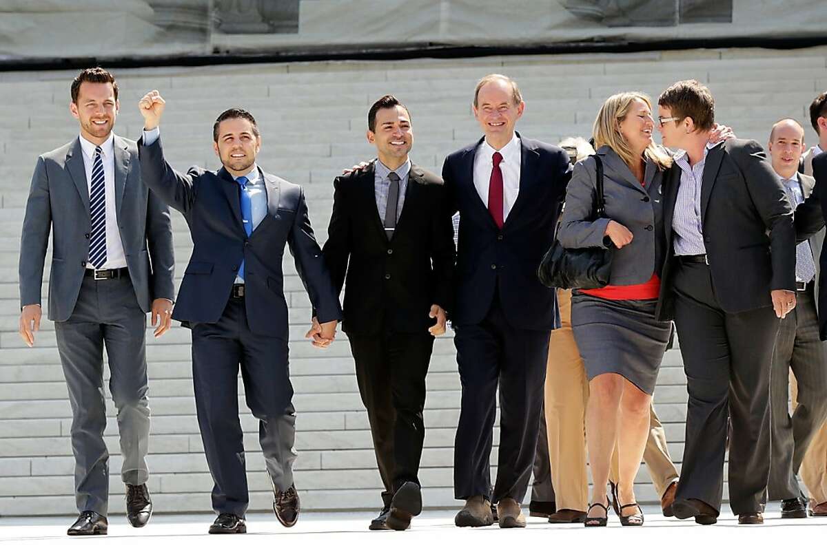 WASHINGTON, DC - JUNE 26: Members of the plaintiff team in the same sex marriage cases before the Supreme Court (L-R) Adam Umhoefer, executive director of the American Foundation for Equal Rights, plaintiff Paul Katami, plaintiff Jeff Zarillo, attorney David Boies, plaintiff Kris Perry and plaintiff Sandy Stier wave from the court's steps after favorable rulings were issued June 26, 2013 in Washington, DC. The high court ruled to strike down DOMA and determined the California's proposition 8 ban on same-sex marriage was not properly before them, declining to overturn the lower court's striking down of the law. (Photo by Win McNamee/Getty Images)