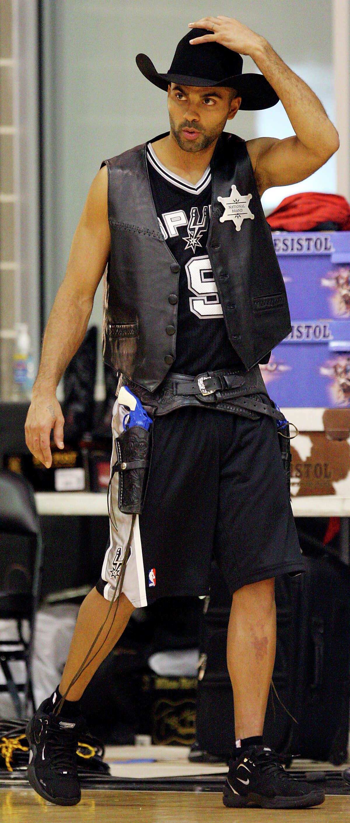 Spurs' Tony Parker adjusts his cowboy hat prior to the filming of an HEB commercial Monday Oct. 4, 2010 at the Spurs practice facility. (PHOTO BY EDWARD A. ORNELAS/eaornelas@express-news.net)