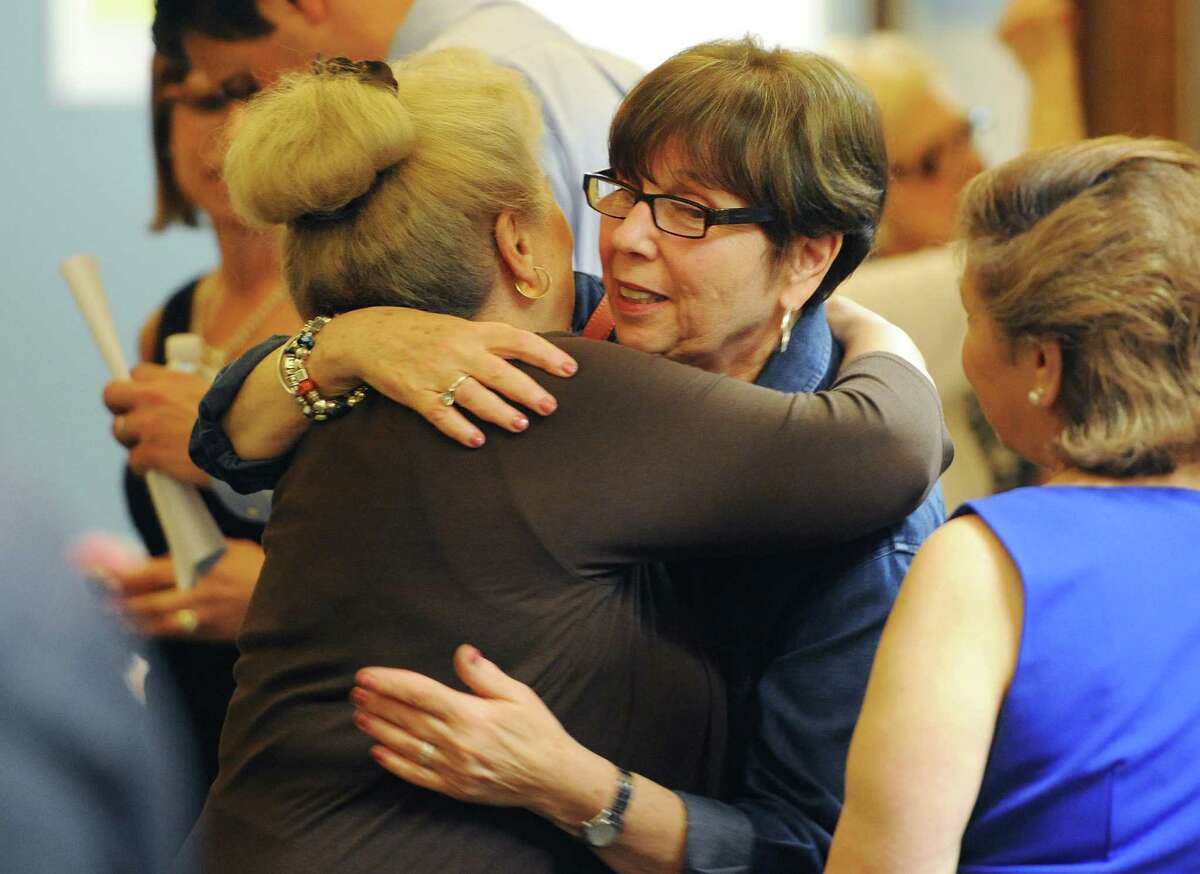 Retiring teachers Barbara Fortunato, left, and Nancy Berman share a hug at the Danbury Public Schools teacher retirement reception at the Danbury Schools Administrative Office in Danbury, Conn. on Wednesday, June 26, 2013. Fortunato taught for 35.9 years, retiring as the kindergarten teacher at Park Ave. Elementary, and Berman taught for 28 years, retiring as the reading teacher at the Alternative Center for Excellence.