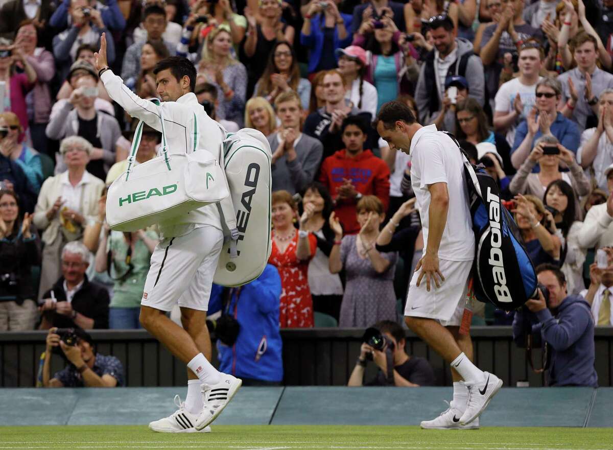Novak Djokovic, left, played his part in ending a 101-year-old streak of an American man reaching the third round as he knocked out Bobby Reynolds, right.