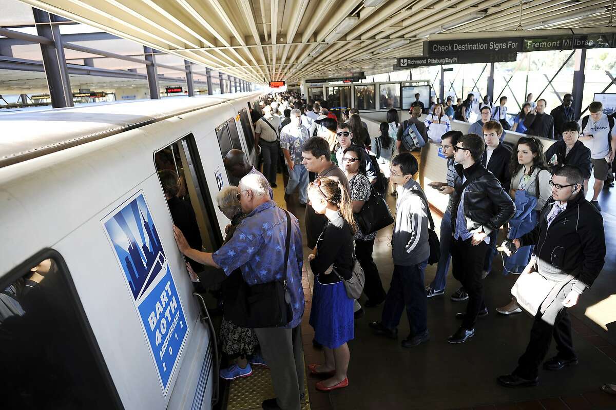 Crowds of commuters wait to board San Francisco bound trains at the MacArthur BART station in Oakland in 2013.