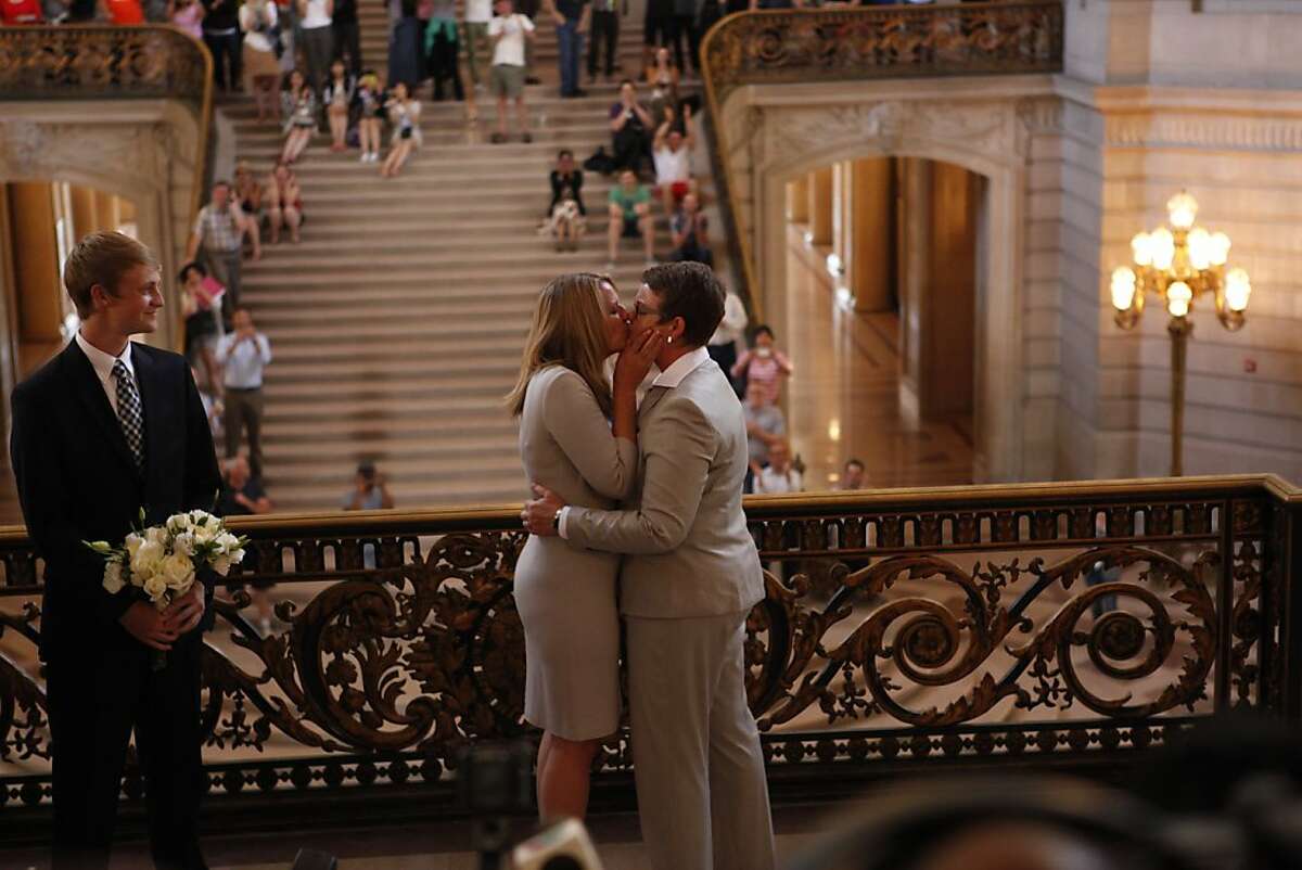 Sandra Stier and Kris Perry of Berkeley, one of the plaintiff couples, are the first couple to be married after the Ninth Circuit Court of Appeals lifted its stay on Friday, June 28, 2013 in San Francisco, Calif. The couple was married by California Attorney General Kamala Harris outside of Mayor Ed Lee's office. At left is the couple's son, Elliot.