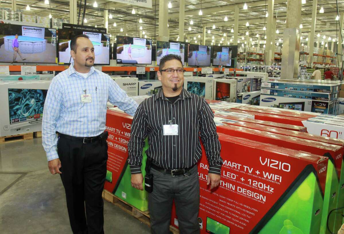 J.P. Polloreno, left, and Manual Juarez work in the major sales department of the Greenway Plaza area Costco. Providing a living wage and "quality and affordable" health care for its employees has been Costco's policy "since Day One," says Richard Galanti, the company's chief financial officer.