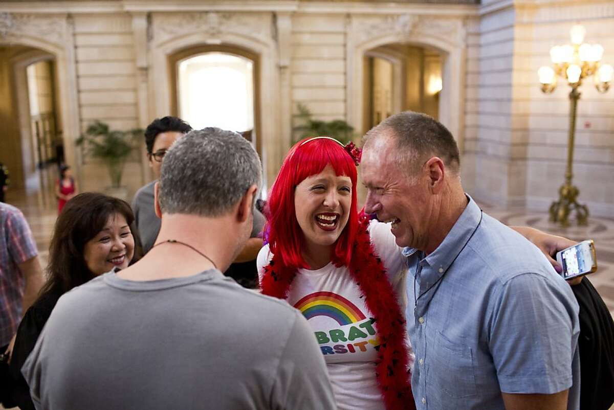 Brandie Yelland, a borrowed witness, congratulates Brian Nolan and Art Cook, of Belmont, after they married in the rotunda at City Hall in San Francisco, Calif., Saturday, June 29, 2013.