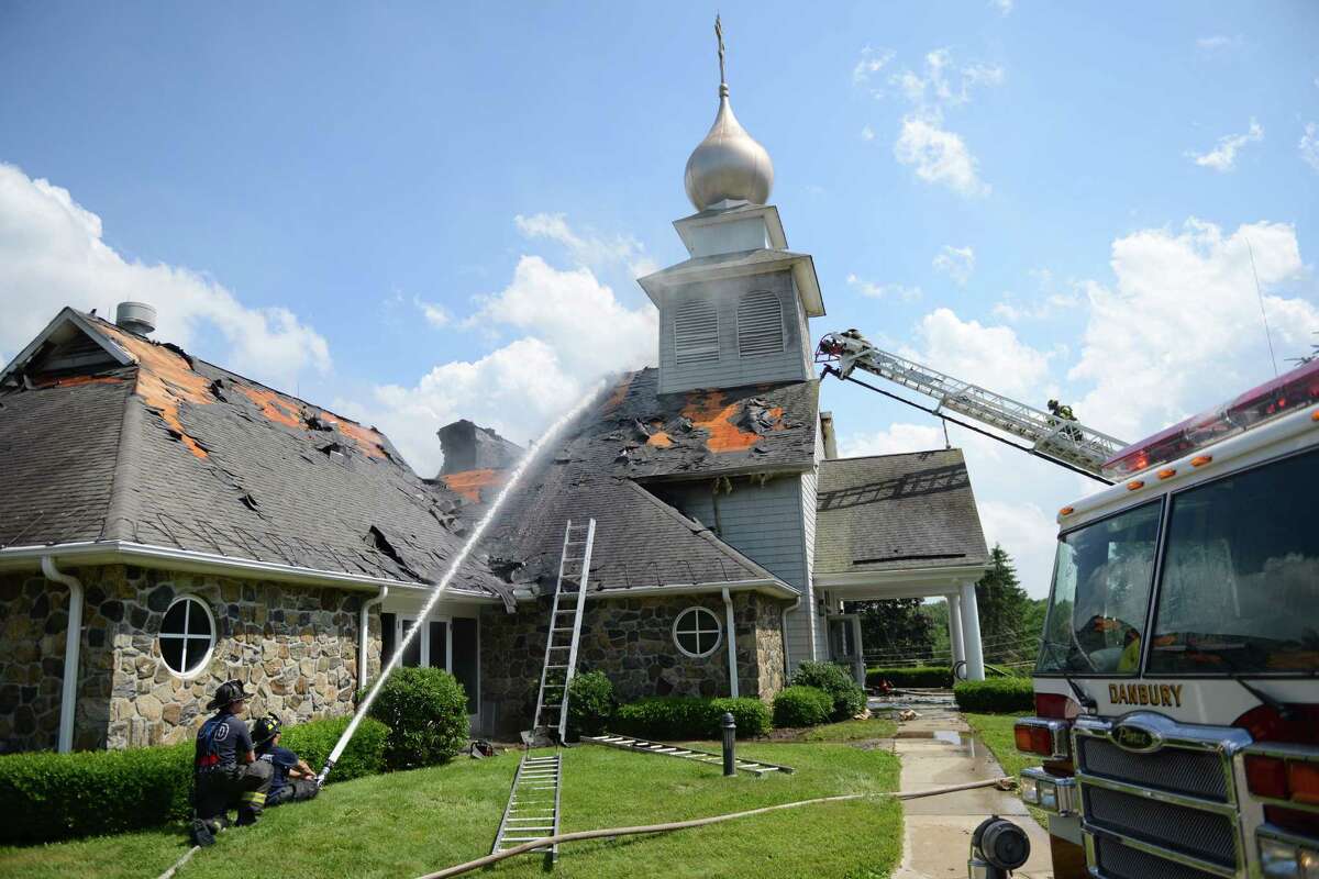 Firefighters work to extinguish the blaze at St. Nicholas Byzantine Catholic Church in Danbury, Conn. on Saturday, June 29, 2013. The church suffered extremely heavy roof and interior damage.