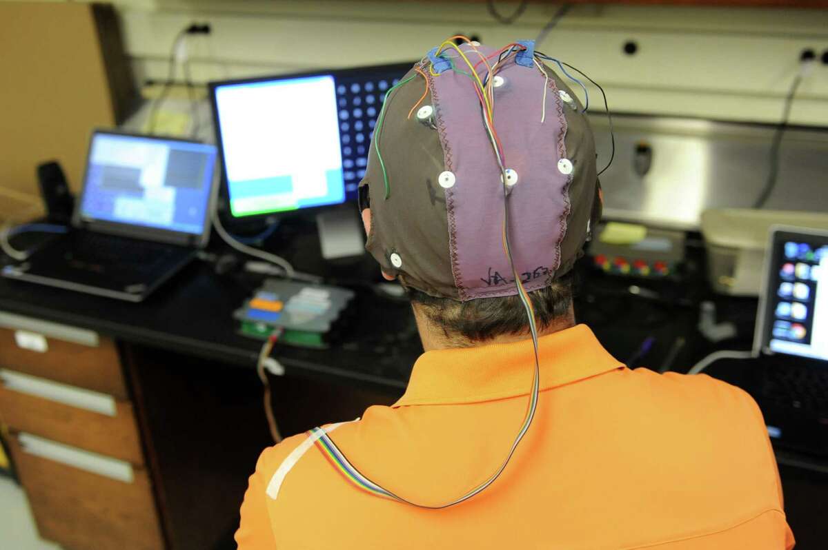 Andrew Wilkinsen wears an EEG cap to write a message with his brain waves while sitting in front of a computer at the Wadsworth Center in Albany in 2013. Similar technology has been developed for rehab use in patients by g.tec. (Lori Van Buren / Times Union)