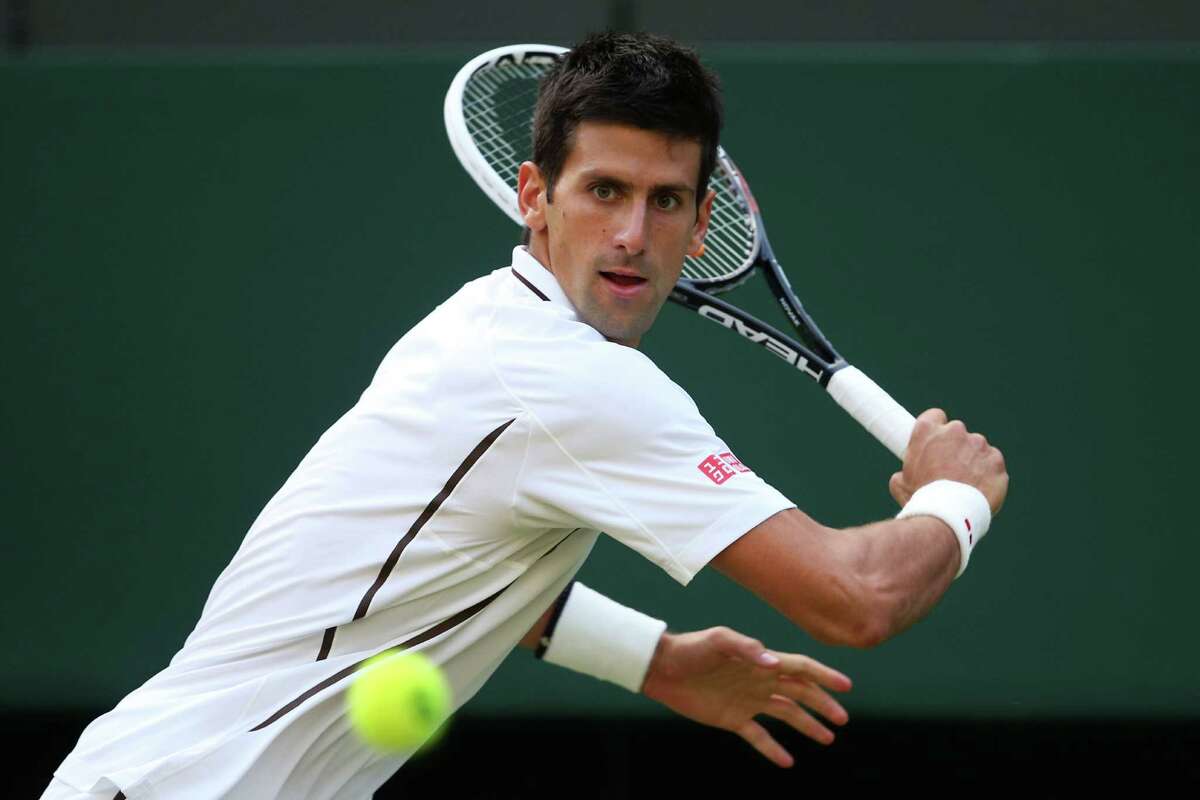 Top seed Novak Djokovic of Serbia concentrates on his backhand during his straight-sets victory over Jeremy Chardy of France on Saturday at Wimbledon. Djokovic committed only three unforced errors.