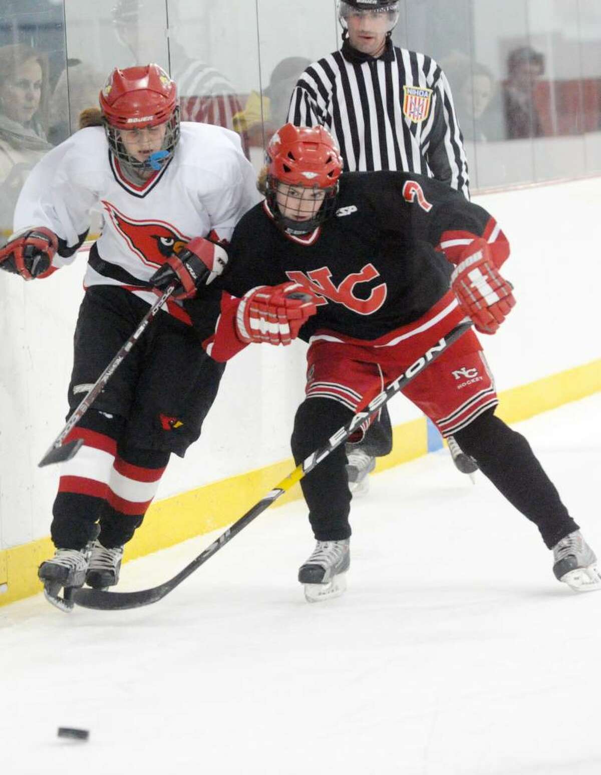 New Canaan's Abbey Buckenheimer shoulders Greenwich's Olivia Tapsall as Greenwich High hosts New Canaan in a girls hockey game at Dorothy Hamill Saturday afternoon, January 16, 2010.