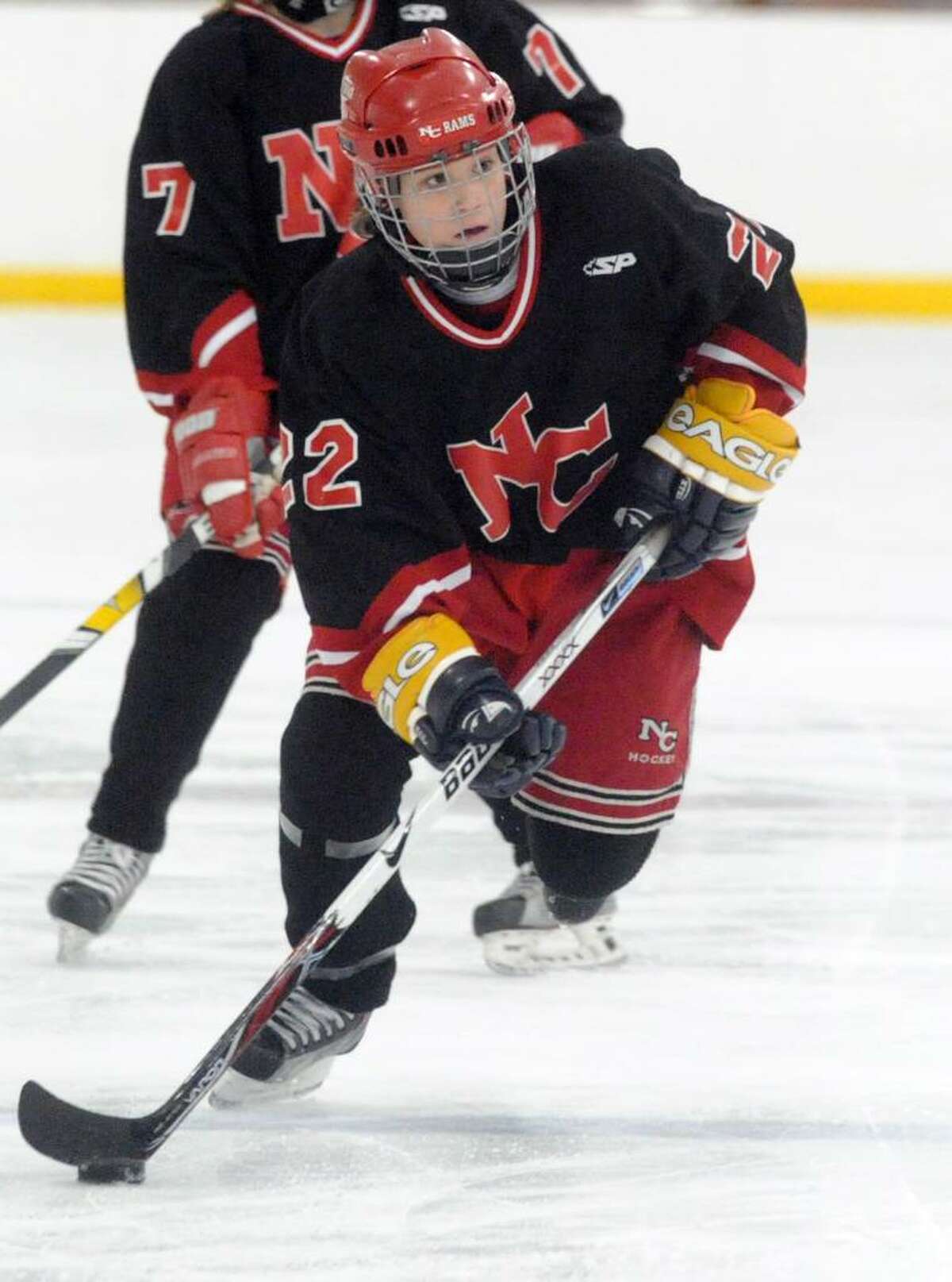 New Canaan's Olivia Hompe breaks away as Greenwich High hosts New Canaan in a girls hockey game at Dorothy Hamill Saturday afternoon, January 16, 2010.