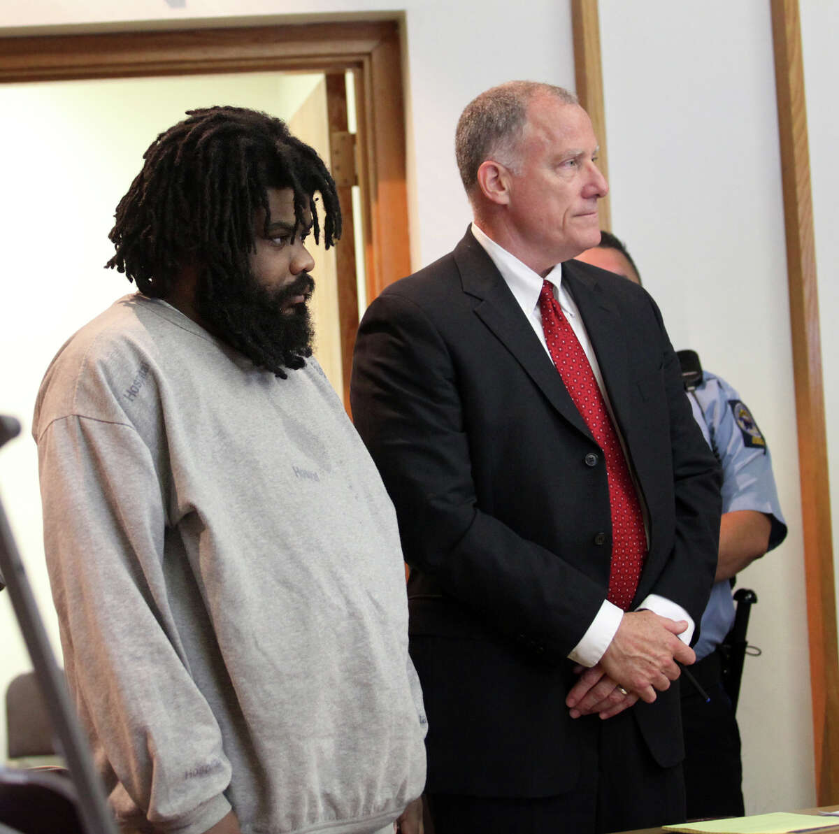 Tyree Smith, left, stands with public defender Joseph Bruckmann on the first day of trial before a three judge panel in Bridgeport, Conn. on Monday, July 1, 2013. Smith is charged with the murder of Angel "Tun Tun" Gonzalez.