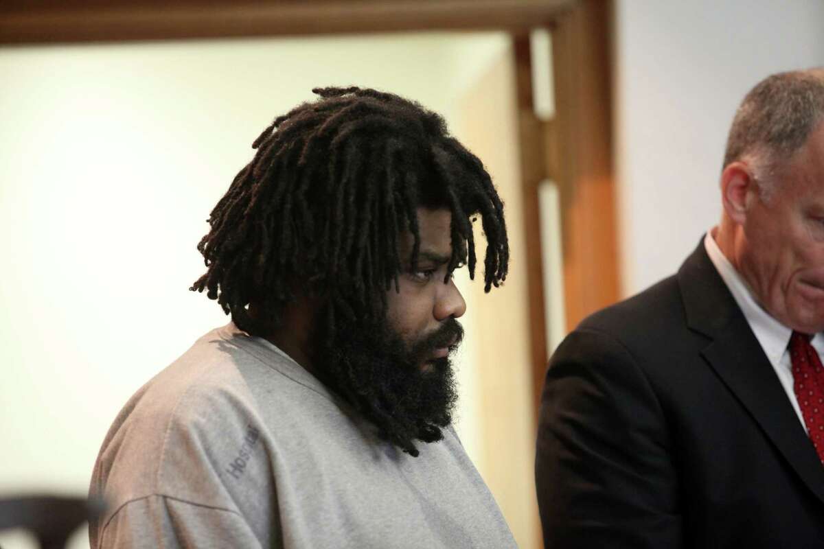 Tyree Smith, left, stands in court on the first day of trial before a three judge panel in Bridgeport, Conn. on Monday, July 1, 2013. Smith is charged with the murder of Angel "Tun Tun" Gonzalez.