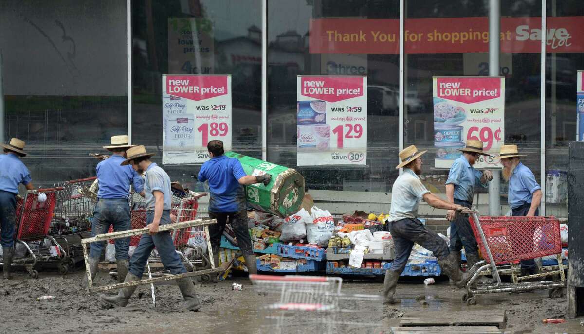 Amish men from nearby communities help flood cleanup efforts at the Save-A-Lot market Monday, July 1, 2013, in Fort Plain, N.Y. Waters from the Mohawk River and its tributaries flooded the community late last week. (Skip Dickstein/Times Union)