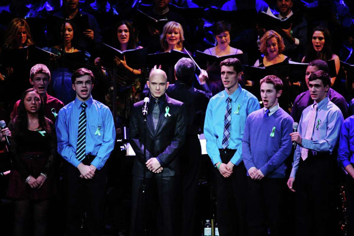 Tony-winning Broadway star Michael Cerveris (center), performs with members of the Newtown High School Chamber Choir, at the "From Broadway With Love" benefit at the Palace Theater in Waterbury on Jan. 28. CPTV and other regional public television outlets will broadcast a special about the event starting Thursday, July 18.