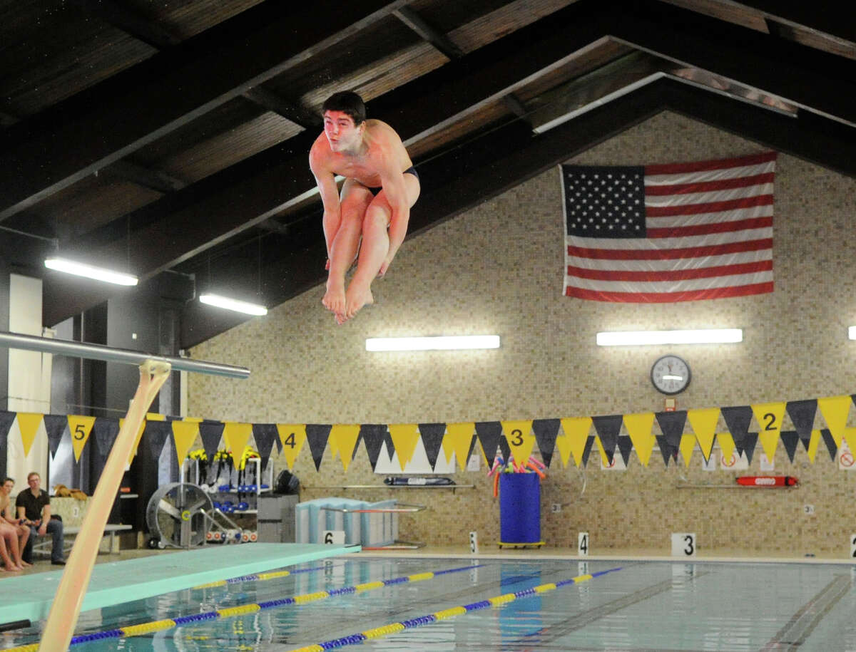 Darien High School diver Jake Bowtell hangs in the air above the pool during meet against Greenwich High School at the Darien YMCA, Wednesday afternoon, Dec. 15, 2010.