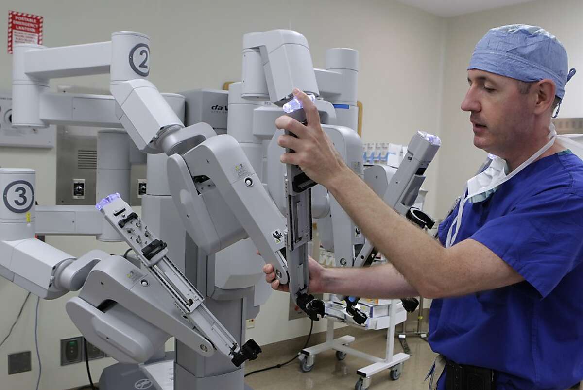 Dr. Ed Damrose prepares the DaVinci surgical robot for a transoral operation at Stanford Medical Center in Stanford, Calif. on Friday, June 28, 2013.