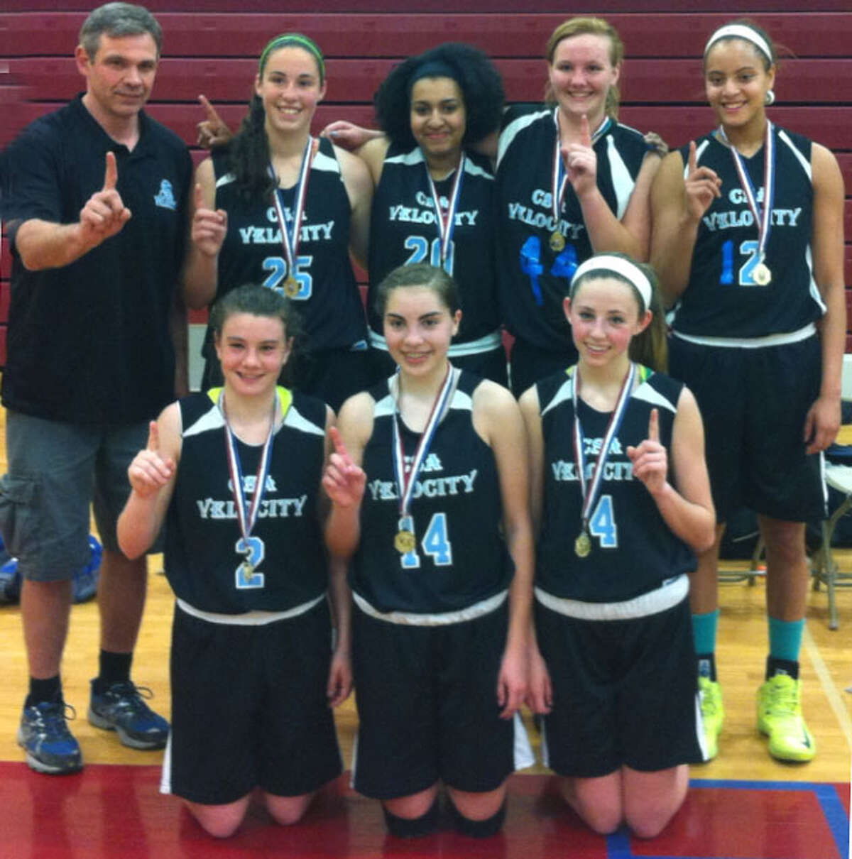 Coach Tom LaPorte and members of the Connecticut Sports Arena's 10th grade Velocity girls' basketball team celebrate their victory in a recent AAU tournament. Courtesy of the Connecticut Sports Arena