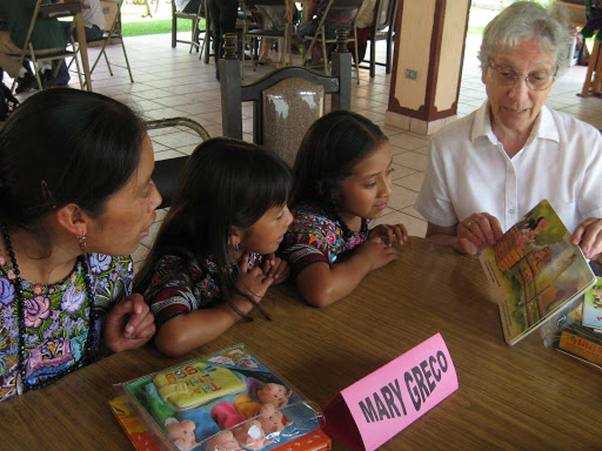 Mary Greco, 82, of Schenectady, the victim of an apparent homicide, is shown here reading to children in a 2008 photo from a mission trip to Guatemala. Greco was a former nun who traveled regularly on international mission trips.