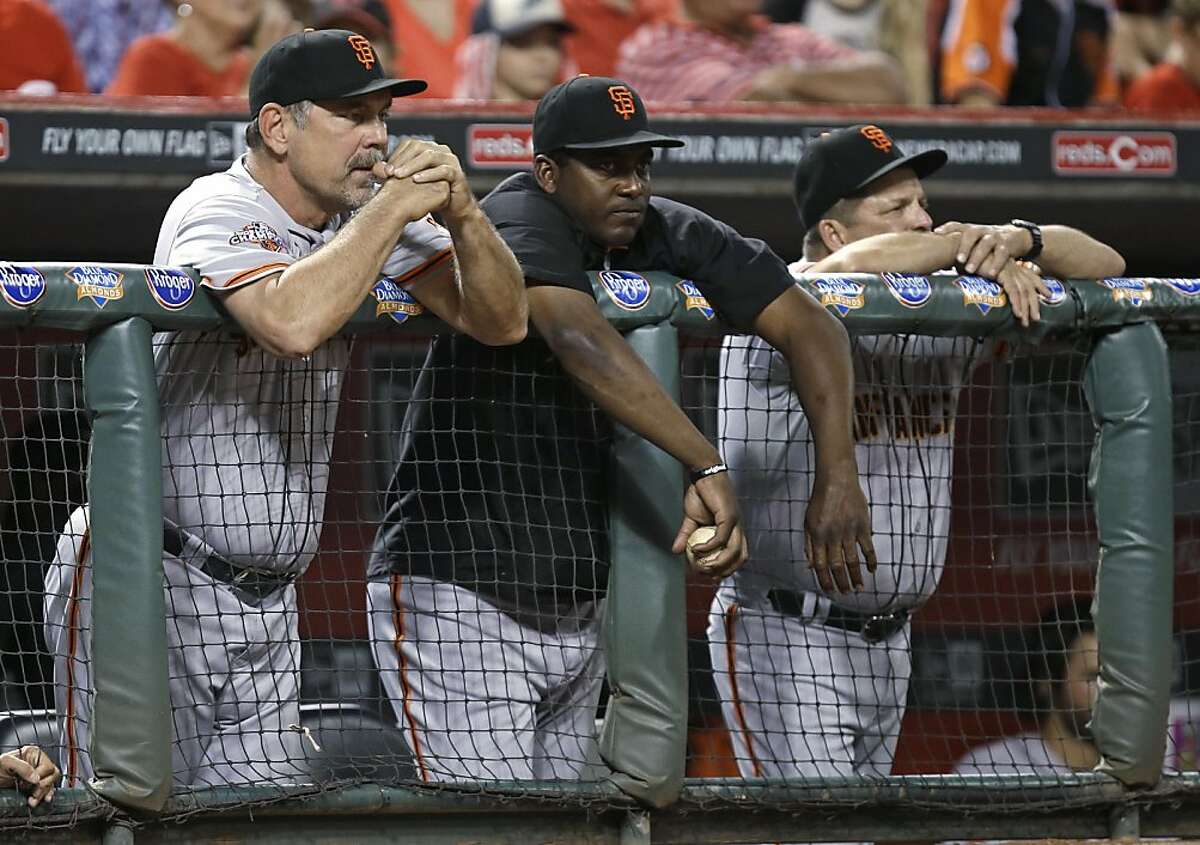 San Francisco Giants manager Bruce Bochy, left, watches from the dugout in the ninth inning of a baseball game against the Cincinnati Reds, Tuesday, July 2, 2013, in Cincinnati. Cincinnati won 3-0 on a no-hitter by Homer Bailey. (AP Photo/Al Behrman)