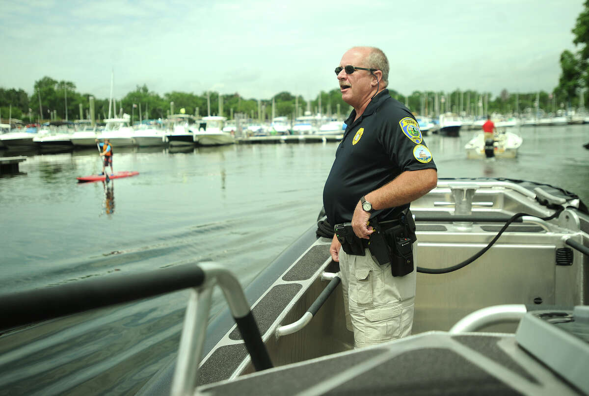 Fairfield Police Marine Unit Officer Greg Carroll surveys the situation as the unit's state-of-the-art police boat heads in to South Benson Marina in Fairfield, Conn. on Wednesday, July 3, 2013.