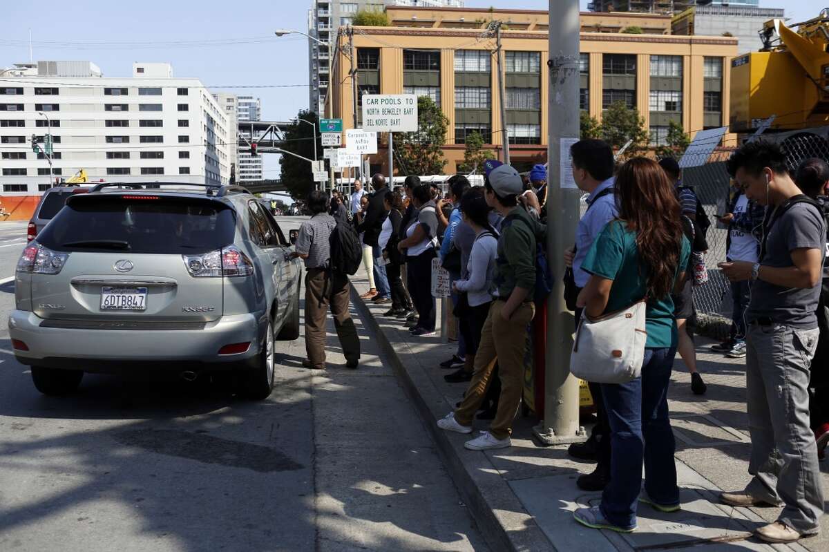 People wait at carpool pickup stops on Beale Street while BART workers are on strike in San Francisco, Calif. on July 1, 2013.
