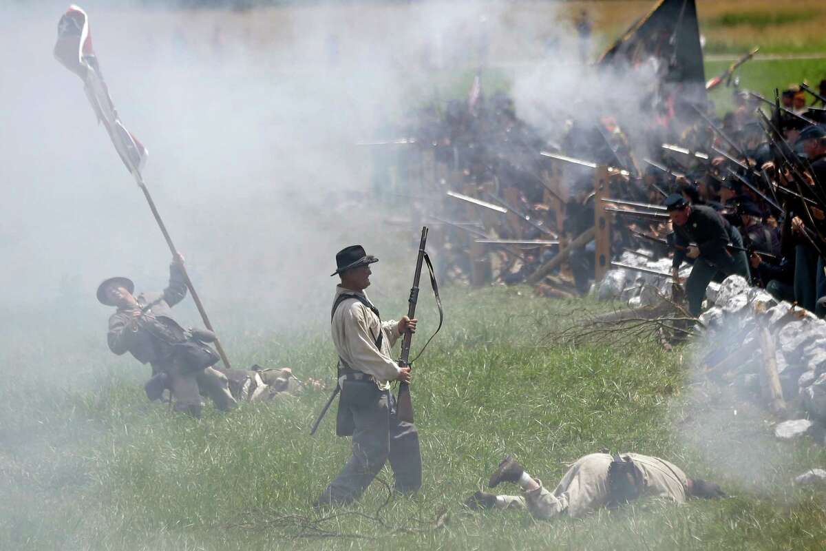 Re-enactors portray Pickett's Charge during activities commemorating the 150th anniversary of the Battle of Gettysburg at Bushey Farm in Gettysburg, Pa.