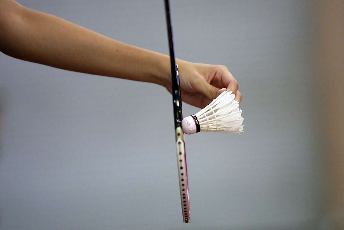 A player prepares to serve a shuttlecock at the U.S. Badminton team practice at the Bay Badminton Center in Burlingame, Calif. on June 27, 2013.