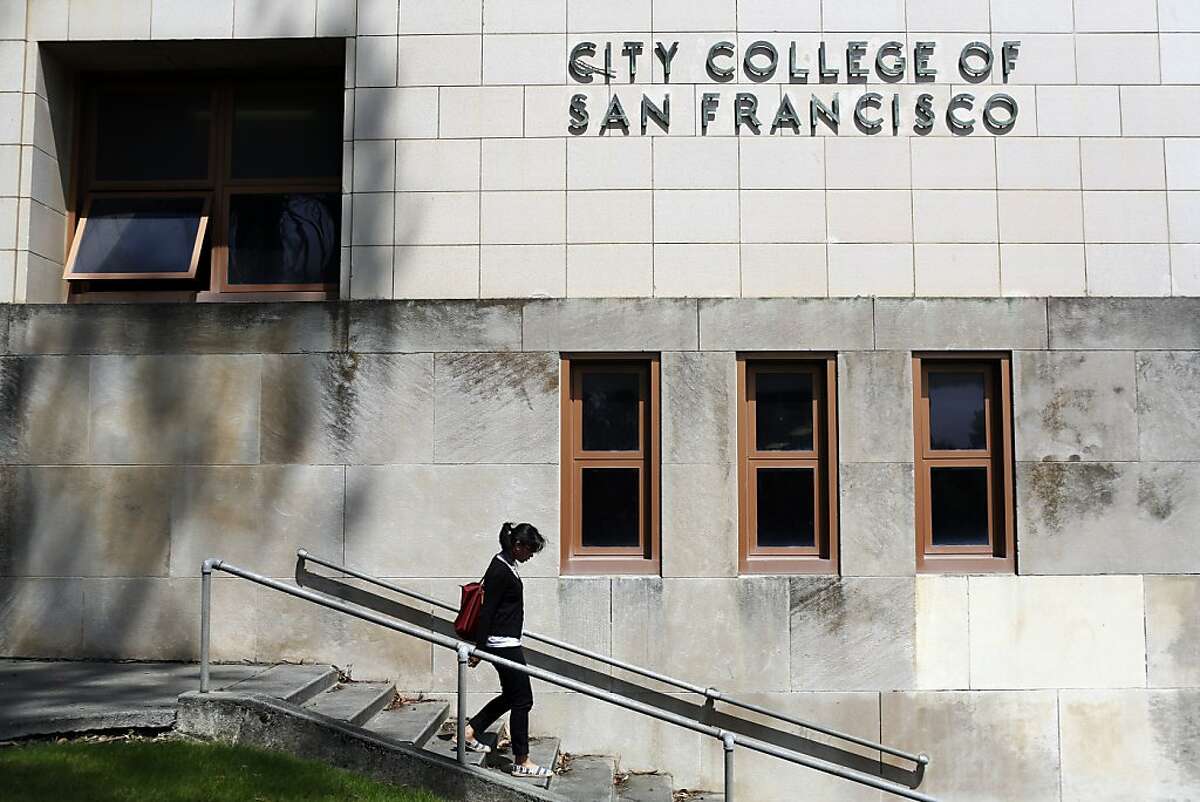 Claudeen Narnac walks down the steps in front of a City College of San Francisco sign which may lose  its accreditation effective on July 31, 2014 in San Francisco.
