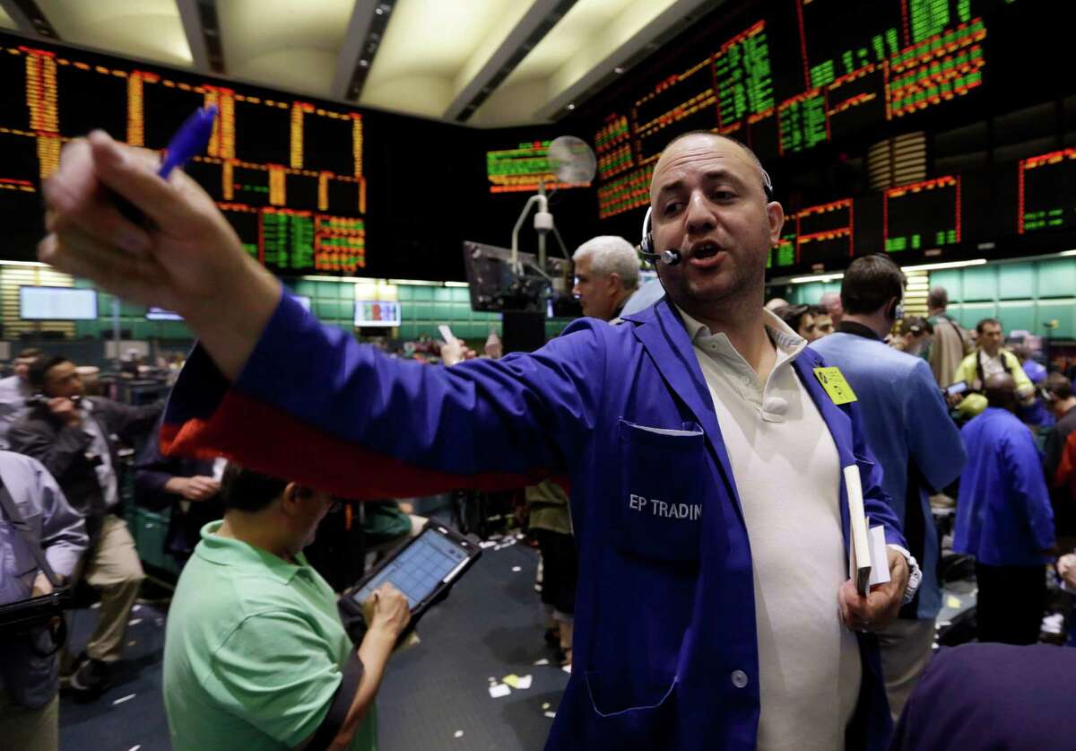 Trader Peter Iocolano works in the oil options pit at the New York Mercantile Exchange Wednesday, July 3, 2013. Oil climbed above $101 a barrel as the political crisis in Egypt intensified. (AP Photo/Richard Drew)