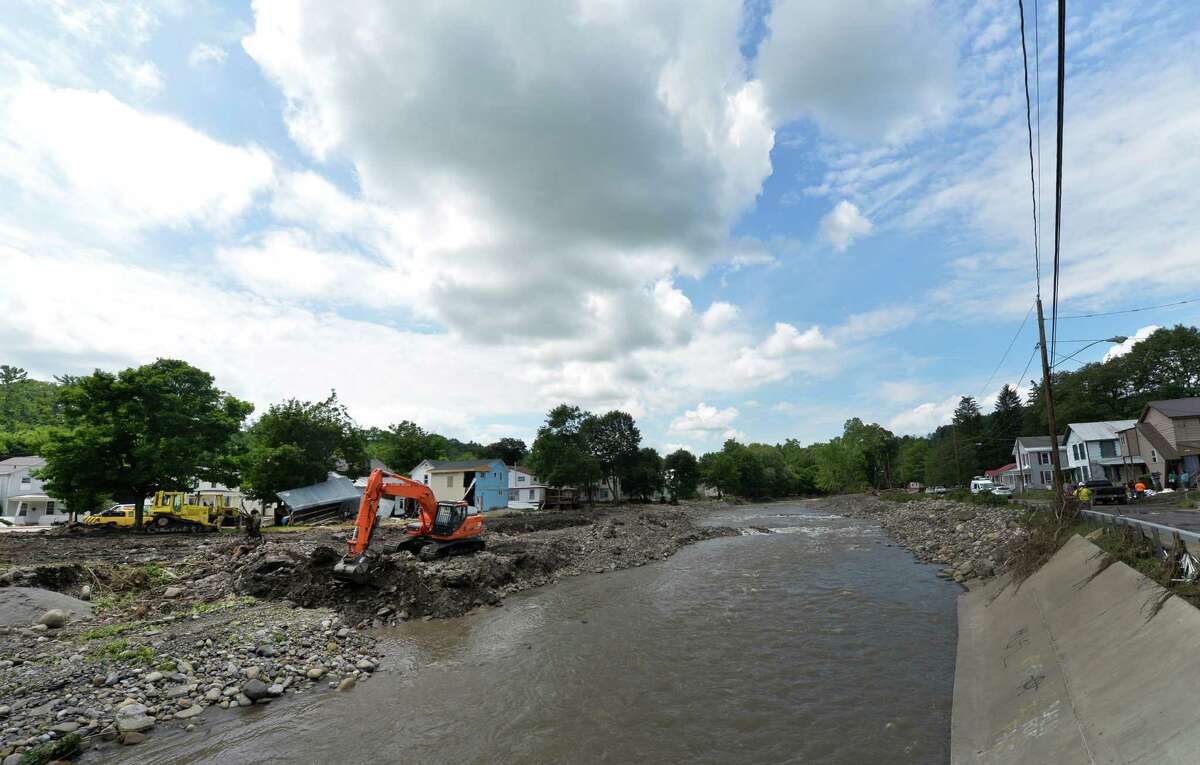 An earth mover works on the banks of the Otsquago Creek Wednesday July 3, 2013, in Fort Plain, N.Y. (Skip Dickstein/Times Union)