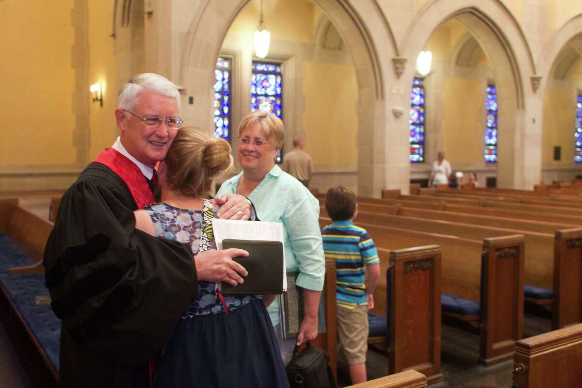 Rev. Jim Bankston, the senior pastor at St. Paul's United Methodist Church is greeted by his granddaughter, Sara Anderson, 13, after his final service at the church after nearly 40 year's as a Methodist minister Sunday, June 30, 2013, in Houston. ( Johnny Hanson / Houston Chronicle )