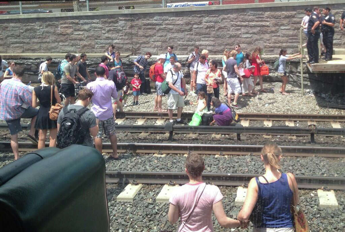 Passengers evacuated from a Metro-North commuter train after a fire was reported on the rear car Thursday, July 4, 2013. No injuries were reported, but service along the New Haven Line has been suspended indefinitely.