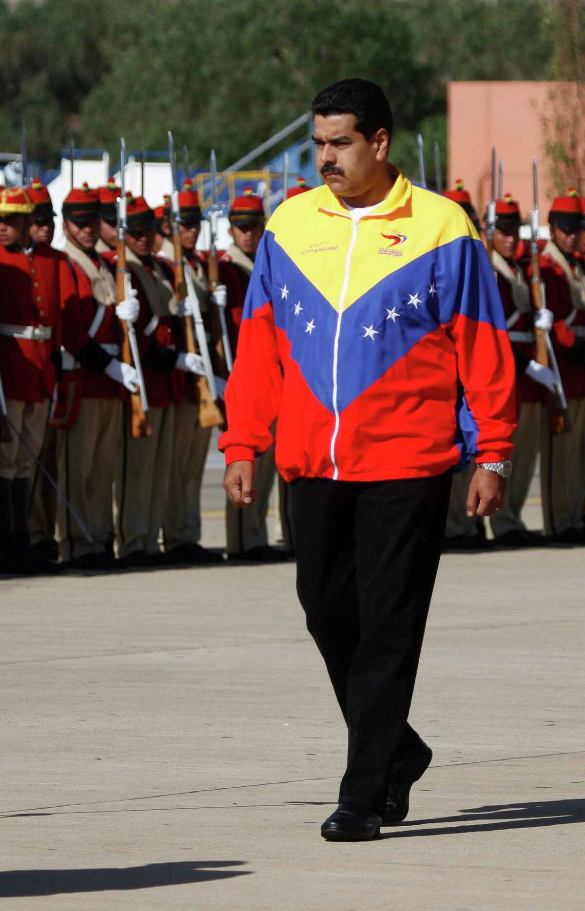 Venezuela's President Nicolas Maduro reviews a honor guard upon his arrival to the airport in Cochabamba, Bolivia, Thursday, July 4, 2013. Maduro is in Cochabamba for an extraordinary meeting of South American leaders to show support for Bolivian President Evo Morales, whose plane was rerouted in Europe, over suspicions that National Security Agency leaker Edward Snowden was on board. (AP Photo/Juan Karita)